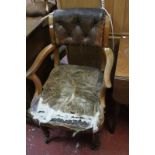A late Victorian button back upholstered desk arm chair, with upholstered back and open arms above