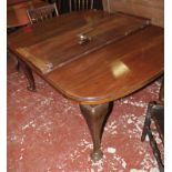 An early 20th century mahogany extending dining table the top with moulded edge above cabriole legs,