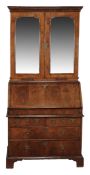 A George II walnut and featherbanded bureau bookcase, circa 1735  A George II walnut and