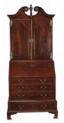 A George II oak bureau bookcase, circa 1750, possibly Anglo-Dutch  A George II oak bureau bookcase,