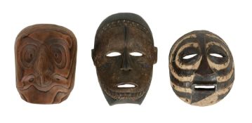 Three African tribal masks , of varying design, 63  Three African tribal masks  , of varying design,