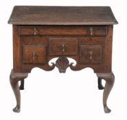 A George II Colonial lowboy , circa 1750, probably American the shaped top...  A George II