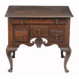 A George II Colonial lowboy , circa 1750, probably American the shaped top...  A George II