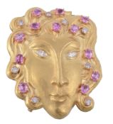 A pink sapphire and diamond mask brooch by Rinaldi  A pink sapphire and diamond mask brooch by