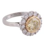 A yellow diamond and diamond cluster ring, the central yellow diamond  A yellow diamond and