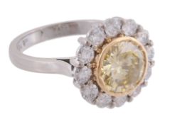 A yellow diamond and diamond cluster ring, the central yellow diamond  A yellow diamond and