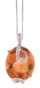 A citrine and diamond pendant, the oval shaped citrine encircled with...  A citrine and diamond