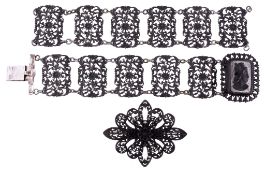 A Berlin iron work bracelet, circa 1810, the five rectangular floral and...  A Berlin iron work
