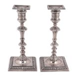 A pair of late Victorian silver candlesticks by Thomas Bradbury & Sons Ltd  A pair of late Victorian