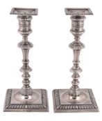 A pair of late Victorian silver candlesticks by Thomas Bradbury & Sons Ltd  A pair of late Victorian