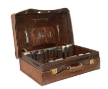 An early 20th century crocodile skin suitcase with silver fittings by...  An early 20th century