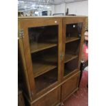 A Queen Anne style walnut china cabinet, with glazed top section on cupboard base and bracket feet