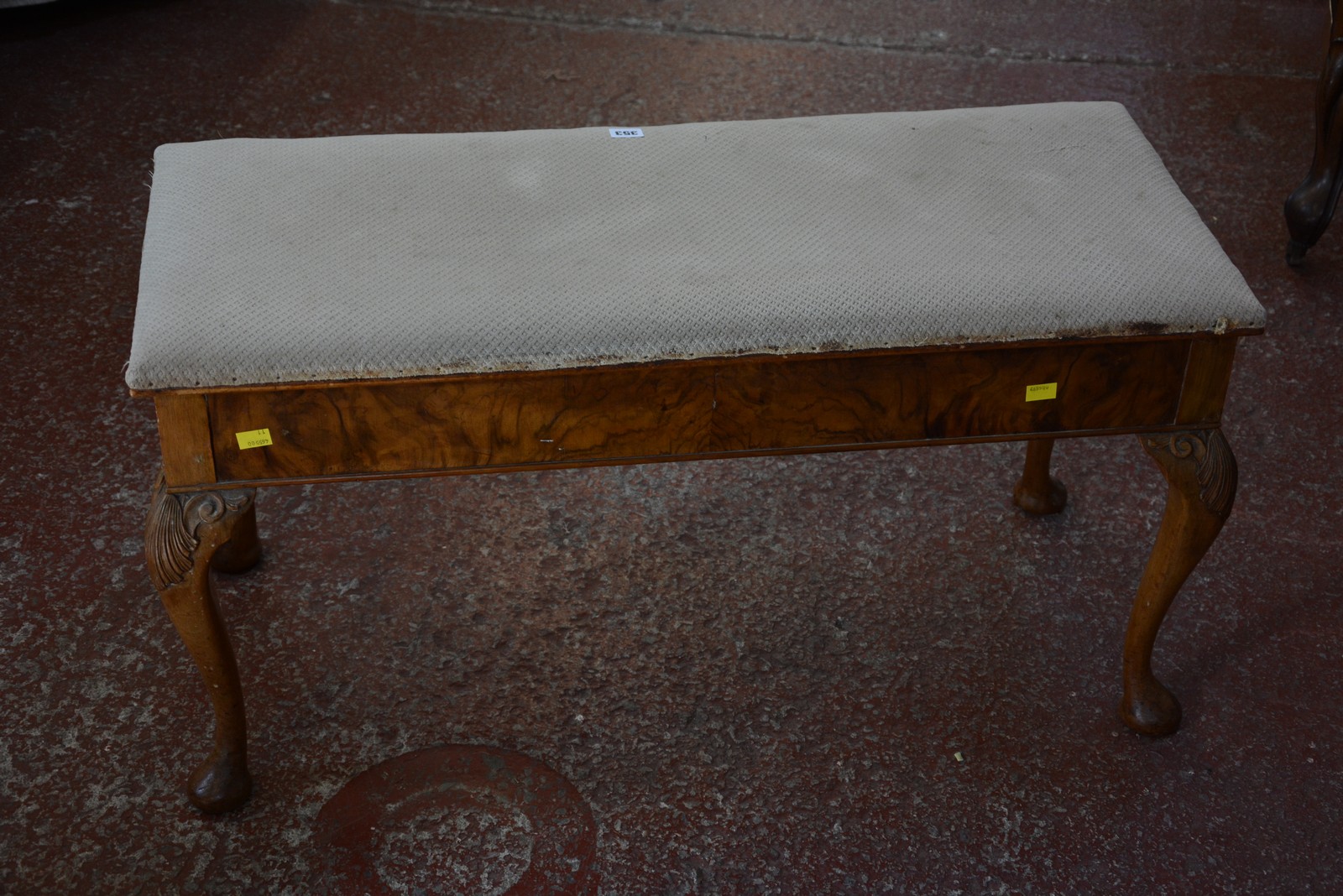 A walnut duet stool with a hinged lid raised on cabriole legs