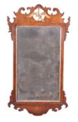 A George III walnut fretwork frame wall mirror, circa 1770, pierced crest centred by a gilt eagle