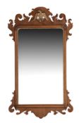 A 19th century walnut and parcel gilt fretwork mirror in George I style, the top with central