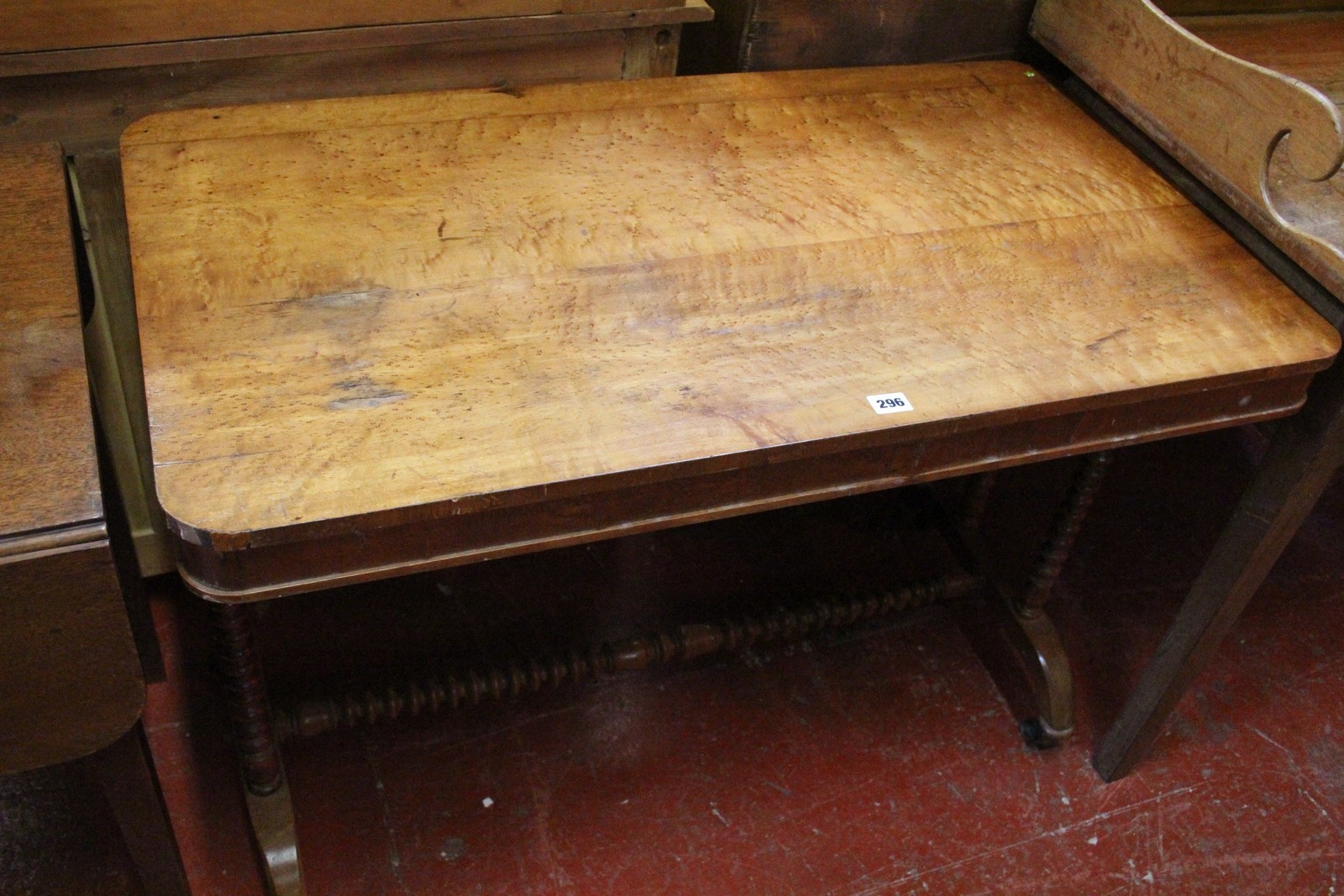 A Victorian birdseye maple writing/library table the rectangular top with rounded corners above