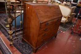 A George III mahogany bureau, circa 1800, with a fitted interior and four long drawers on bracket