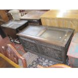 A 19th Century oak coffer with carved front panels.