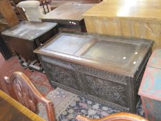 A 19th Century oak coffer with carved front panels.