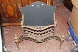 An Edwardian style firegrate with arched back, baluster finials and serpentine front 71cm high, 75cm