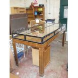 A Biedermeier style shop display counter, with glazed top and six fold down doors.212.5cm w X 90.5cm