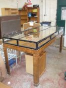 A Biedermeier style shop display counter, with glazed top and six fold down doors.212.5cm w X 90.5cm