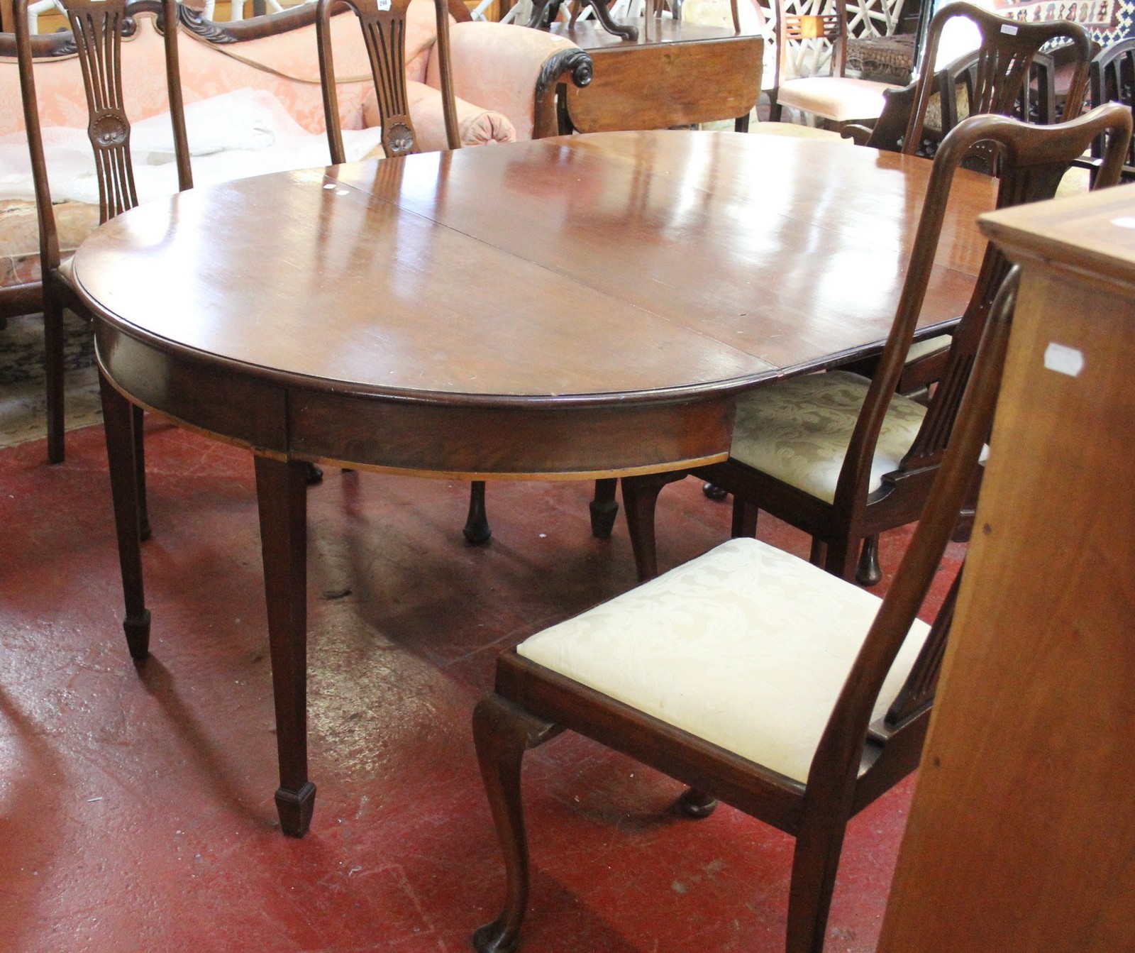 A late George III mahogany D-end dining table, circa 1800, the top with moulded edge above D-ends,