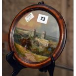 A mother of pearl and painted scene of a Continental town, circular, 19th century, 14.5cm in
