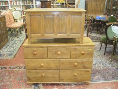 A reproduction wood panelled blanket box, and a pine effect modern chest of drawers.