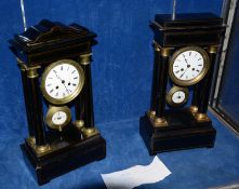 A 19th Century French ebonised and ormolu mounted portico mantel clock, the white enamel dial within