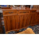 * A breakfront yew wood cabinet.