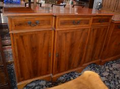 * A breakfront yew wood cabinet.