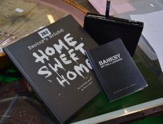 Three volumes of books by Banksy, "Banging Your Head", "Existentialism" and "Cut It Out", a
