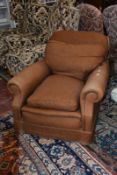 An early 20th Century upholstered brown armchair. Best Bid