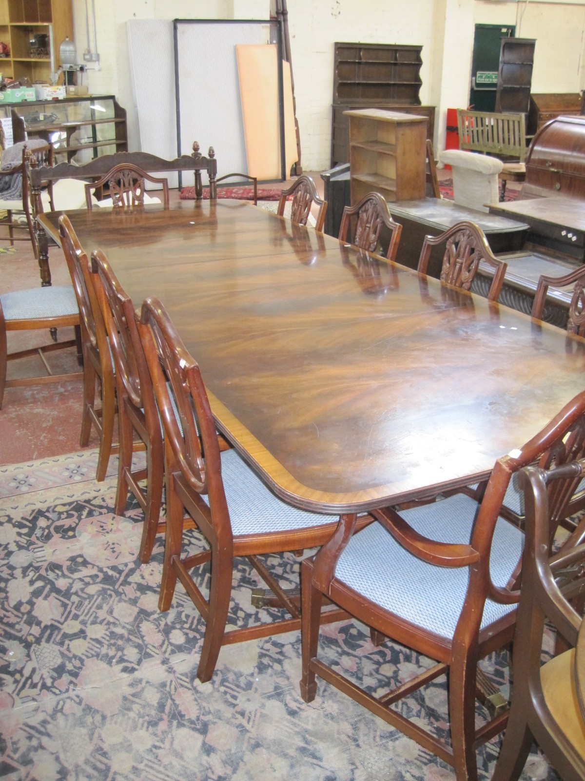 * A Regency style mahogany twin pedestal crossbanded dining table with three additional leaves 320cm
