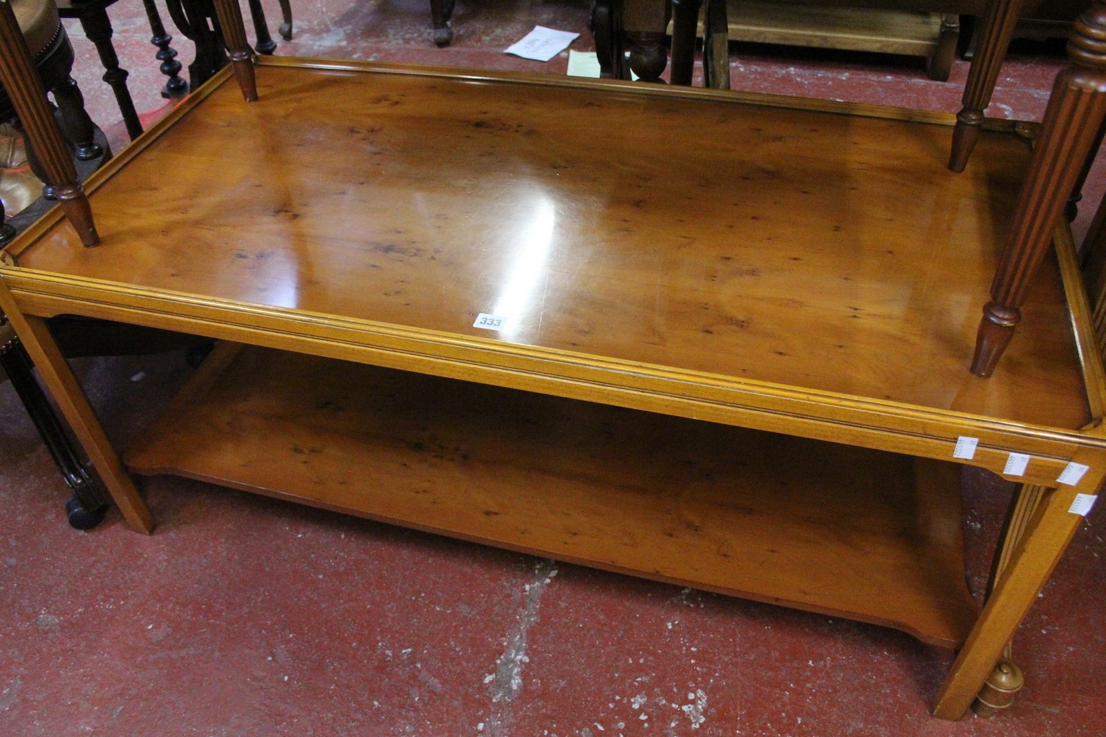 A modern yew rectangular two tier occasional table 50cm high, the top 120cm x 60cm. Best Bid