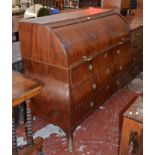 A Dutch mahogany roll top bureau, early 19th century with a fitted interior with drawers below.