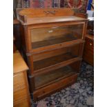 A Globe Wernicke three section bookcase with drawer to plinth base 130cm high, 90cm wide, 32cm