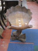 A walnut 'grotto' chair with dolphin carved support and swivel seat