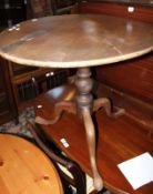 A George III mahogany tilt top table with circular top above turned pillar and tripod base, 68cm