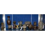 An assortment of twelve late 19th Century Chinese and Japanese bronze vases and two wooden stands