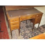 An Edwardian writing table with brass gallery.