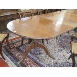 A Regency style D end dining table with two extension leaves raised on twin swept pedestals.