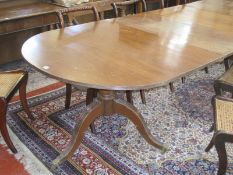 A Regency style D end dining table with two extension leaves raised on twin swept pedestals.