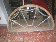 A demi-lune mirror, wooden mounted, (made from a Georgian window), 99cm wide