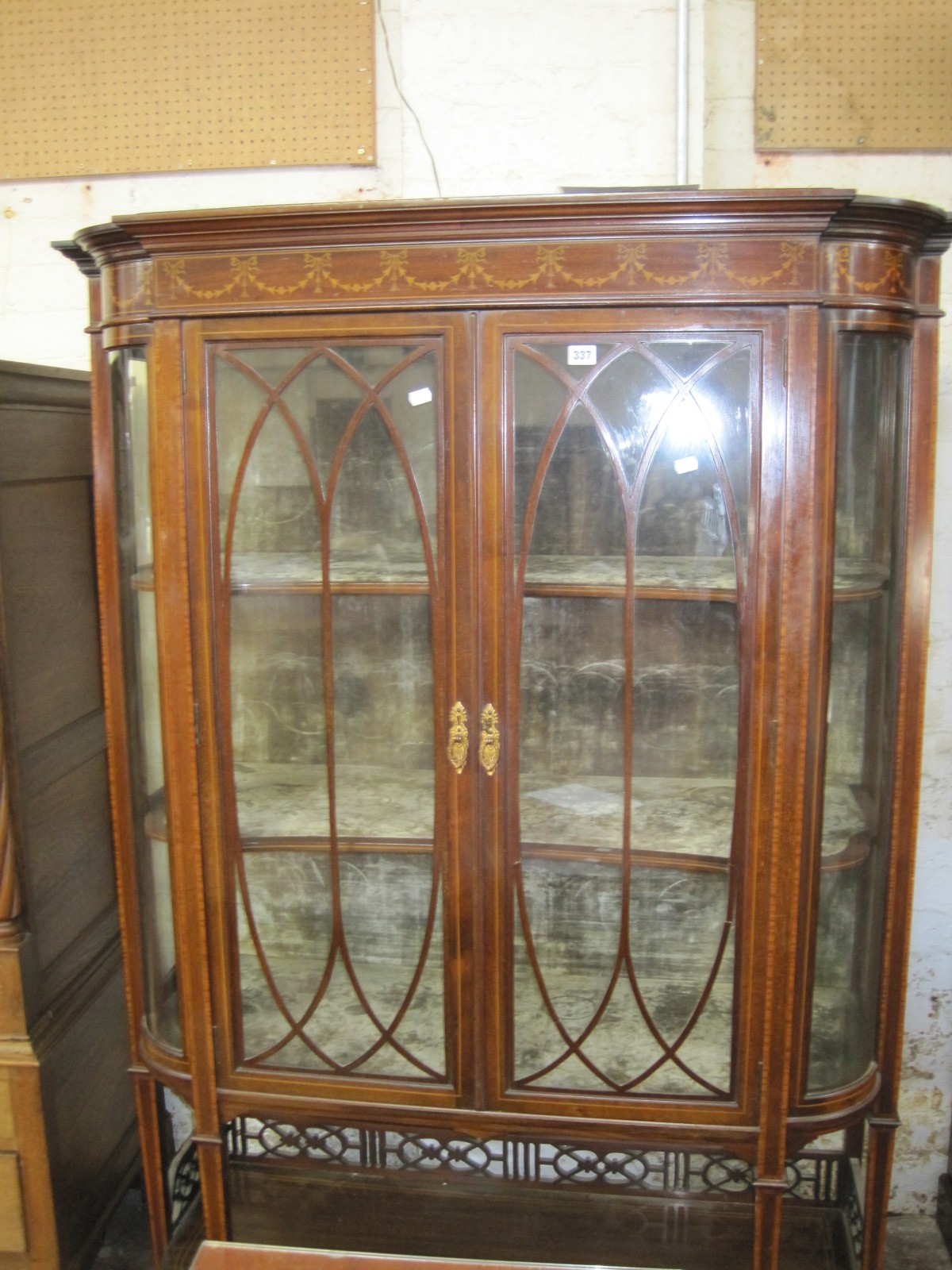 An Edwardian china display cabinet in the Sheraton Revival style.