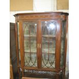 An Edwardian china display cabinet in the Sheraton Revival style.