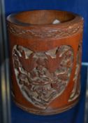A Chinese bamboo brush pot carved with a bat and figures.15cm high.