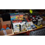 A quantity of die cast cars, boxed radio controlled car, Mini RC Helicopters, a hover craft etc. (as