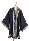 A Chinese midnight blue winter robe, with deep sleeve bands embroidered with colourful silks showing